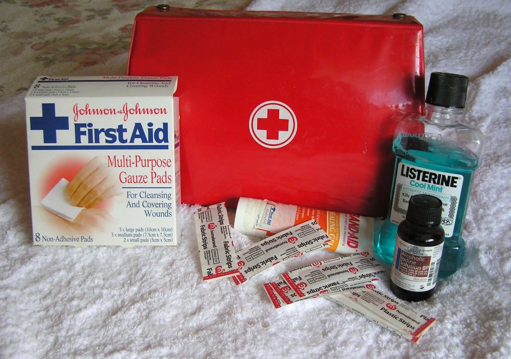 First aid kit, listerine, bandaids, and other items going in a car emergency kit