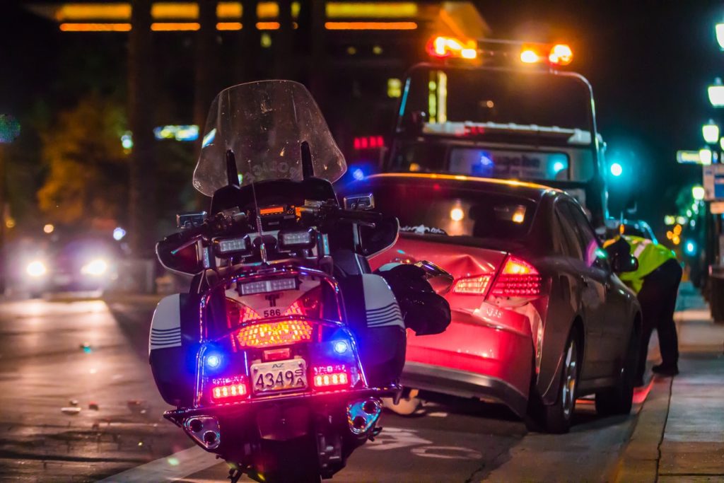 police motorcycle behind a car being towed