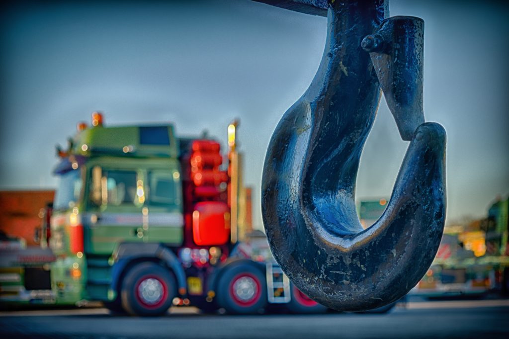 Tow truck hook with a truck blurred in the background