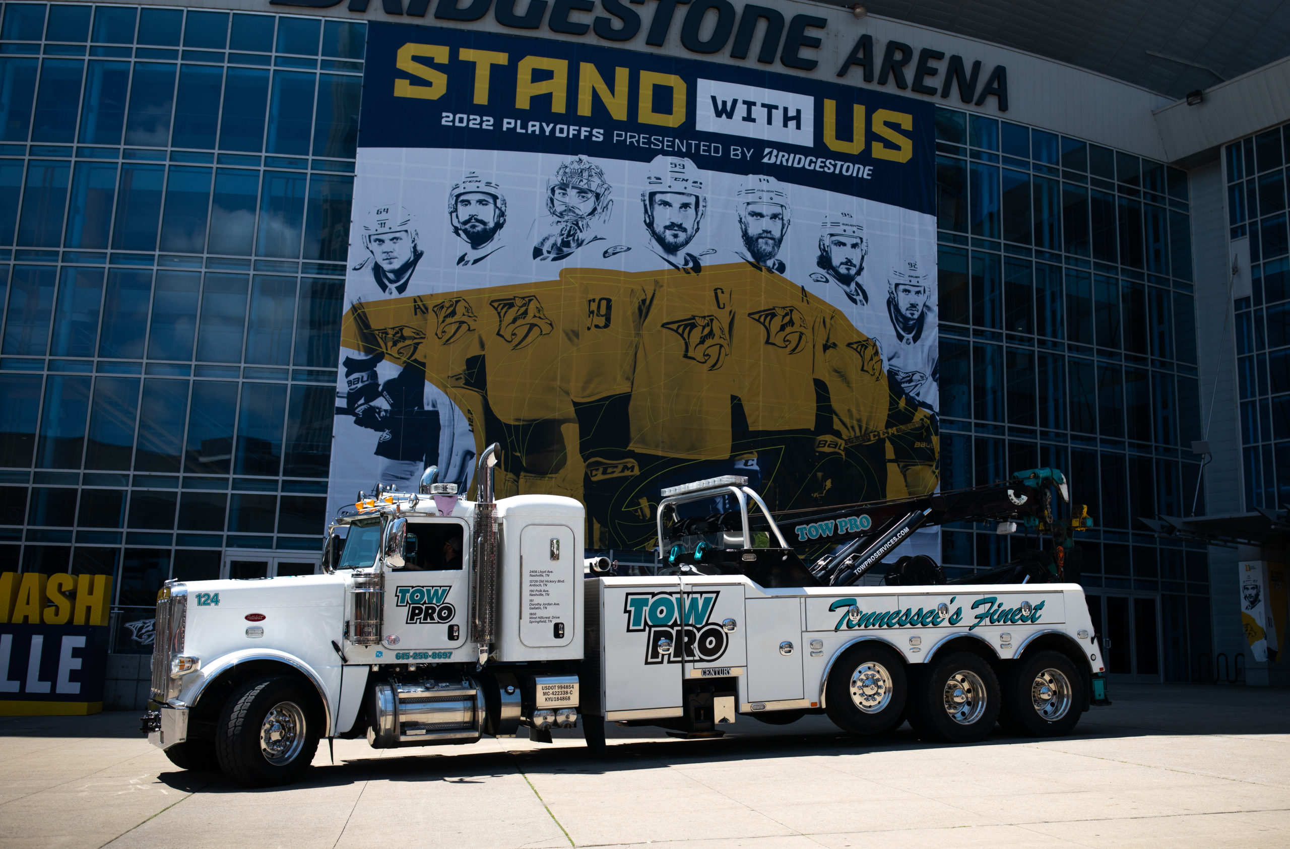 Tow Pro Nashville hauling truck in front of Nissan Stadium