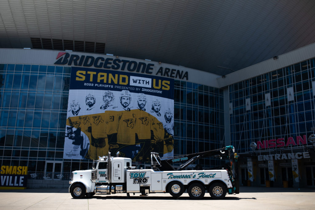 Tow Pro towing truck in front of Bridgestone arena in Nashville