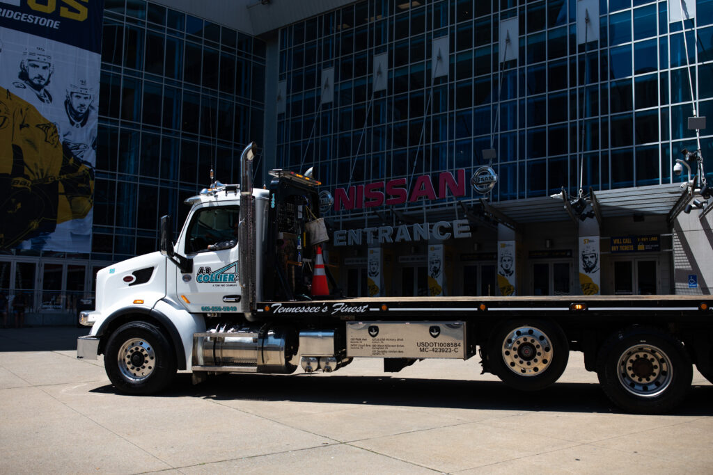 A side view of a heavy duty A.B. Collier truck outside the Nissan Stadium in Nashville, TN.